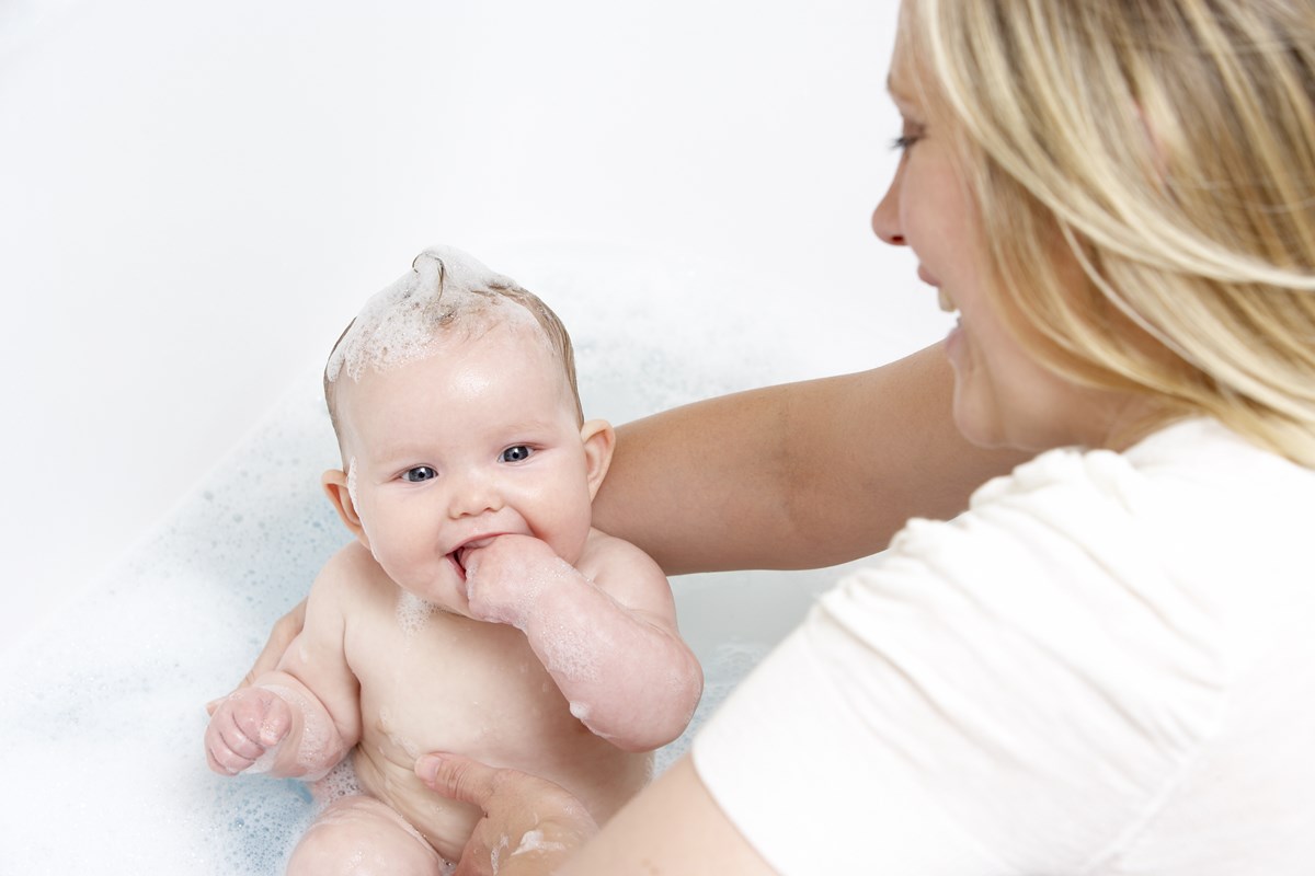 Домашний уход новорожденным. Мама с малышом в ванне. Мама купает ребенка. Мама моет ребенка. Гигиена новорожденного девочки.
